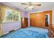 Cozy bedroom features vintage details, blue carpet, and a well-lit window at 8840 Niwot Rd, Niwot, CO 80503