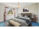 Cozy staged bedroom features a neutral palette, large window and unique blue carpet at 8840 Niwot Rd, Niwot, CO 80503