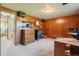 Bedroom features paneling, built in shelves, a desk and an open doorway at 8840 Niwot Rd, Niwot, CO 80503