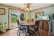 Charming dining room with a round table, a ceiling fan, and a view to the backyard at 8840 Niwot Rd, Niwot, CO 80503