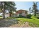 Charming two-story brick home featuring a well-maintained lawn and a classic front porch at 8840 Niwot Rd, Niwot, CO 80503