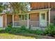 Inviting front porch with white railing and lush landscaping creating a warm welcome at 8840 Niwot Rd, Niwot, CO 80503