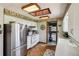 Efficient kitchen layout with stainless steel appliances, white cabinets, and adjacent laundry at 8840 Niwot Rd, Niwot, CO 80503