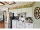 Functional kitchen with white appliances, ample cabinet space, and a decorative accent wall at 8840 Niwot Rd, Niwot, CO 80503
