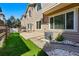 An open backyard, complete with artificial turf, a small patio, and sliding glass doors at 12925 Grant Cir # A, Thornton, CO 80241