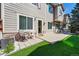 A cozy backyard patio area with pavers, artificial turf, and a sliding door entryway at 12925 Grant Cir # A, Thornton, CO 80241