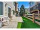 Backyard featuring artificial turf, a small patio, and a classic wooden fence at 12925 Grant Cir # A, Thornton, CO 80241