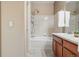 Clean, neutral bathroom with a bath/shower, sink, tiled walls and floors at 12925 Grant Cir # A, Thornton, CO 80241