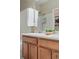 Bathroom featuring double sinks with a tiled backsplash, a large mirror, and white towels at 12925 Grant Cir # A, Thornton, CO 80241