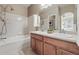 Bright bathroom with a double vanity, shower over bath and large mirror at 12925 Grant Cir # A, Thornton, CO 80241