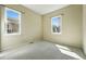Comfortable carpeted bedroom featuring bright windows and neutral walls at 12925 Grant Cir # A, Thornton, CO 80241