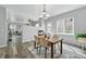 Dining room with modern lighting, fireplace, hardwood floors and open to the living room at 12925 Grant Cir # A, Thornton, CO 80241