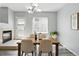 Dining room with modern lighting, fireplace, lots of natural light and hardwood style floors at 12925 Grant Cir # A, Thornton, CO 80241