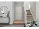 Inviting foyer featuring tile flooring, staircase, and neutral decor at 12925 Grant Cir # A, Thornton, CO 80241