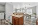 Open kitchen with view into dining room, stainless steel appliances and lots of light at 12925 Grant Cir # A, Thornton, CO 80241