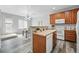 Kitchen and dining area with stainless steel appliances and warm, inviting cabinetry at 12925 Grant Cir # A, Thornton, CO 80241
