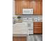 Close up of kitchen with modern appliances, light countertops and stainless steel sink at 12925 Grant Cir # A, Thornton, CO 80241