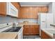 Modern kitchen with stainless appliances, light countertops, and warm cabinetry at 12925 Grant Cir # A, Thornton, CO 80241