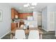 Kitchen and dining area with stainless steel appliances and warm, inviting cabinetry at 12925 Grant Cir # A, Thornton, CO 80241
