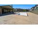 An empty pool is surrounded by a large concrete deck and a covered lounge area at 12925 Grant Cir # A, Thornton, CO 80241