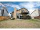 View of a two-story home, with deck, and fenced backyard at 1296 Ascot Ave, Highlands Ranch, CO 80126