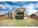 Backyard view featuring two-story home with a wooden deck and a storage shed at 1296 Ascot Ave, Highlands Ranch, CO 80126