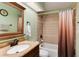 Bathroom with decorative tile, vanity with a large mirror, and shower/bathtub combination with a shower curtain at 1296 Ascot Ave, Highlands Ranch, CO 80126