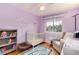 Charming Bedroom with hardwood floors, crib, patterned rug, a chair, and decorated with mountains and uplifting words at 1296 Ascot Ave, Highlands Ranch, CO 80126