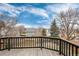 Spacious wooden deck with black railings overlooking the backyard and neighborhood at 1296 Ascot Ave, Highlands Ranch, CO 80126