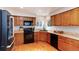 Well-lit kitchen with wooden cabinets, modern appliances, and light countertops at 1296 Ascot Ave, Highlands Ranch, CO 80126