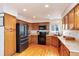 Spacious kitchen featuring warm wood cabinets, granite counters, and modern appliances at 1296 Ascot Ave, Highlands Ranch, CO 80126