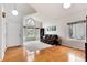 Open living room with high ceilings, hardwood floors, and large windows at 1296 Ascot Ave, Highlands Ranch, CO 80126