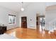 Open-concept living room with hardwood floors leads into dining area at 1296 Ascot Ave, Highlands Ranch, CO 80126
