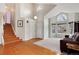 Open-concept living room with hardwood floors, stairs to the left and neutral walls at 1296 Ascot Ave, Highlands Ranch, CO 80126