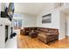 Inviting living room with fireplace, large sectional couch, and natural light at 1296 Ascot Ave, Highlands Ranch, CO 80126