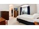 Bright main bedroom with walk-in closet, dresser, and sliding glass doors at 1296 Ascot Ave, Highlands Ranch, CO 80126