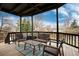 Covered porch with table and chair set creating a relaxing space at 1296 Ascot Ave, Highlands Ranch, CO 80126