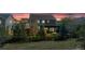 Exterior view of home's backyard with manicured lawn and pergola covered patio at dusk at 7665 Grady Cir, Castle Rock, CO 80108