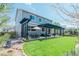 Spacious backyard with a lush lawn, patio with pergola, and an outdoor dining set at 7665 Grady Cir, Castle Rock, CO 80108
