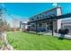 Beautiful backyard featuring a large lawn and a covered patio with outdoor furniture at 7665 Grady Cir, Castle Rock, CO 80108