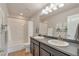 Bathroom featuring double sinks, modern fixtures, and a shower-tub combo creating a clean and functional design at 7665 Grady Cir, Castle Rock, CO 80108