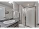 Bright bathroom featuring modern vanity and shower stall with glass door at 7665 Grady Cir, Castle Rock, CO 80108