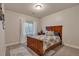 Cozy bedroom featuring a wood-framed bed and natural light from the window at 7665 Grady Cir, Castle Rock, CO 80108