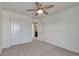 Clean bedroom features plush carpet, a ceiling fan, and double door closet at 7665 Grady Cir, Castle Rock, CO 80108