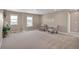 Spacious bonus room featuring neutral paint, large windows, and cozy seating at 7665 Grady Cir, Castle Rock, CO 80108
