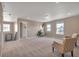Bright bonus room features comfortable patterned chairs, plush carpet, and two windows at 7665 Grady Cir, Castle Rock, CO 80108