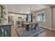 Open kitchen and dining area featuring a large wooden table and stainless steel appliances at 7665 Grady Cir, Castle Rock, CO 80108
