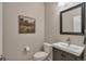 Efficient half bathroom with neutral tones, modern fixtures, and framed art at 7665 Grady Cir, Castle Rock, CO 80108