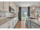 Bright kitchen with granite countertops, stainless appliances, and access to the outdoor space at 7665 Grady Cir, Castle Rock, CO 80108