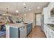 Open-concept kitchen with an island connecting the dining area with granite countertops at 7665 Grady Cir, Castle Rock, CO 80108
